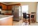 Spacious kitchen featuring wood cabinets, stainless steel appliances, and a dining area at 4522 Weeping Willow Cir, Casselberry, FL 32707