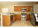 Modern kitchen with stainless steel appliances, granite countertops, and light wood cabinets at 4522 Weeping Willow Cir, Casselberry, FL 32707