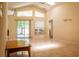 Open living room with a skylight, tile floors, and a sliding glass door to the outside at 4522 Weeping Willow Cir, Casselberry, FL 32707
