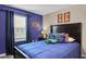 Vibrant bedroom with blue walls, Florida Gator decor, and a cozy bed at 4800 Lullaby Ln, Kissimmee, FL 34746