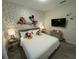 Nicely decorated bedroom featuring playful Mickey Mouse accents and cozy furnishings at 4800 Lullaby Ln, Kissimmee, FL 34746