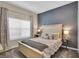 Comfortable bedroom with a neutral color scheme, decorative lamps, and a textured accent wall at 4800 Lullaby Ln, Kissimmee, FL 34746