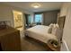 Serene bedroom featuring a king bed, accent chair, and a view of an adjacent bathroom at 4800 Lullaby Ln, Kissimmee, FL 34746