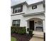 Charming two-story home featuring a covered entrance with a bench and meticulously maintained landscaping at 4800 Lullaby Ln, Kissimmee, FL 34746