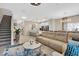 Open-concept living space showcasing a modern kitchen, comfortable seating, a staircase, and bright natural light at 4800 Lullaby Ln, Kissimmee, FL 34746