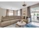 Cozy living room with a plush sectional sofa, stylish decor, and sliding glass doors leading to an outdoor area at 4800 Lullaby Ln, Kissimmee, FL 34746