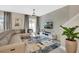 Elegant living area featuring a large sectional sofa, contemporary decor, and a textured accent wall for added visual interest at 4800 Lullaby Ln, Kissimmee, FL 34746