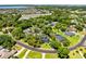 Scenic aerial view of a neighborhood with lush greenery, a pond, and well-maintained homes at 5297 Mill Stream Dr, St Cloud, FL 34771