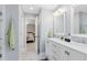 Bathroom features double sinks, marble countertop, vanity, tile floors, mirrors, and a walk-in shower at 5297 Mill Stream Dr, St Cloud, FL 34771