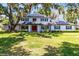 Beautiful two-story home with solar panels, a red front door, and a well-maintained lawn at 5297 Mill Stream Dr, St Cloud, FL 34771