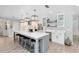 Modern kitchen with a large center island, stylish pendant lighting, stainless steel appliances, and sleek countertops at 5297 Mill Stream Dr, St Cloud, FL 34771