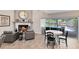 Open-concept living space with a fireplace, dining area, and a view of the screened-in pool, offering a serene atmosphere at 5297 Mill Stream Dr, St Cloud, FL 34771