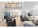Spacious living room with soaring ceilings, an open staircase, and seamless flow into the kitchen and dining areas at 5297 Mill Stream Dr, St Cloud, FL 34771