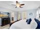 Spacious main bedroom with ceiling fan and view into ensuite bathroom at 5297 Mill Stream Dr, St Cloud, FL 34771