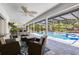 Relaxing outdoor living space featuring a covered patio with comfortable seating overlooking the sparkling pool at 5297 Mill Stream Dr, St Cloud, FL 34771