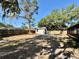 View of large, grassy backyard with white storage shed and fenced perimeter at 560 Garden Heights Dr, Winter Garden, FL 34787