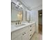 Bright bathroom with a double sink vanity, gold hardware, and stylish mirrors at 560 Garden Heights Dr, Winter Garden, FL 34787