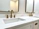 Bright bathroom featuring a double sink vanity with brass hardware and stylish mirrors at 560 Garden Heights Dr, Winter Garden, FL 34787