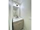 This bathroom features a cream colored vanity with gold hardware and a stylish mirror at 560 Garden Heights Dr, Winter Garden, FL 34787