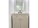 This bathroom features a cream colored vanity with gold hardware and a stylish mirror at 560 Garden Heights Dr, Winter Garden, FL 34787