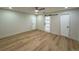 Bedroom with wood-look floors, neutral paint, recessed lighting, and a unique barn door at 560 Garden Heights Dr, Winter Garden, FL 34787