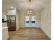 Cozy dining area featuring French doors to a screened patio and a stylish light fixture at 560 Garden Heights Dr, Winter Garden, FL 34787