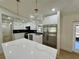 Renovated kitchen with white cabinetry, stainless appliances, a large center island, and modern lighting at 560 Garden Heights Dr, Winter Garden, FL 34787