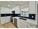 Bright kitchen featuring stainless appliances, white cabinets, and a dark patterned backsplash at 560 Garden Heights Dr, Winter Garden, FL 34787