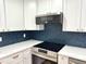 Close up on a modern kitchen featuring new stainless steel appliances and stylish backsplash and countertops at 560 Garden Heights Dr, Winter Garden, FL 34787