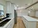 Bright kitchen features stainless appliances, an island with quartz counters, and modern pendant lighting at 560 Garden Heights Dr, Winter Garden, FL 34787