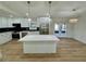 Modern kitchen featuring an island, stainless steel appliances, and unique backsplash at 560 Garden Heights Dr, Winter Garden, FL 34787