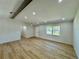 Open living room boasts new floors, neutral paint, and a large window offering lots of natural light at 560 Garden Heights Dr, Winter Garden, FL 34787