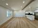 Bright living room with wood floors and recessed lighting leading to the kitchen at 560 Garden Heights Dr, Winter Garden, FL 34787