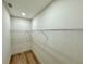 Bright walk-in closet features clean white walls, wire shelving, and wood-look flooring at 560 Garden Heights Dr, Winter Garden, FL 34787