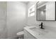 Modern bathroom with white vanity, granite countertop, black faucet, and tiled shower at 5612 Meridian Way, Orlando, FL 32808