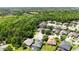 Overhead shot of a serene residential area surrounded by dense greenery, showcasing cozy homes in a peaceful setting at 5815 Pine Grove Run, Oviedo, FL 32765