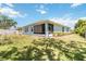 Fenced backyard with an exterior view of the house with a screened-in patio and partial shadow coverage at 5815 Pine Grove Run, Oviedo, FL 32765