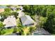 Aerial view of backyard with screened-in pool, mature landscaping, and partial view of house at 5815 Pine Grove Run, Oviedo, FL 32765