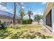 Green backyard featuring a pool area, a white fence, and various trees at 5815 Pine Grove Run, Oviedo, FL 32765