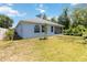 Exterior view of a single story home and spacious green backyard at 5815 Pine Grove Run, Oviedo, FL 32765
