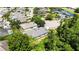 Aerial view of backyard with pond view, mature landscaping, and partial view of house at 5815 Pine Grove Run, Oviedo, FL 32765