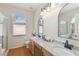 Bathroom with double sinks, wooden vanity, and granite countertops at 5815 Pine Grove Run, Oviedo, FL 32765