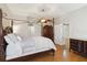 This bedroom features a four-poster bed, wood flooring, and neutral wall paint at 5815 Pine Grove Run, Oviedo, FL 32765