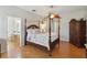 This bedroom has wood flooring, a four-poster bed, and a large cabinet at 5815 Pine Grove Run, Oviedo, FL 32765