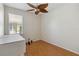 Well-lit room with a faux-wood floor, ceiling fan, and large window offers a calm space to relax at 5815 Pine Grove Run, Oviedo, FL 32765