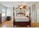 This bedroom features a wooden four-poster bed and a unique leaf-bladed ceiling fan at 5815 Pine Grove Run, Oviedo, FL 32765
