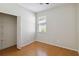 Neutral bedroom featuring a wood-look floor, closet with shelving, and a bright window view at 5815 Pine Grove Run, Oviedo, FL 32765