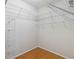 A walk-in closet with white wire shelving and wood floors at 5815 Pine Grove Run, Oviedo, FL 32765