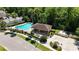 Aerial view of community pool and pavilion surrounded by mature landscaping and tall palm trees at 5815 Pine Grove Run, Oviedo, FL 32765