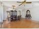A spacious dining room featuring wood floors, a formal table, and large windows at 5815 Pine Grove Run, Oviedo, FL 32765